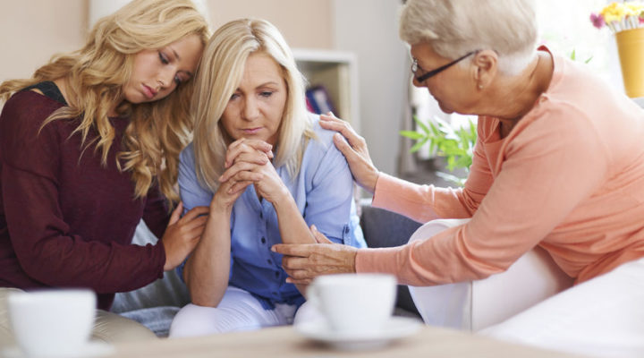 Woman being supported by her family